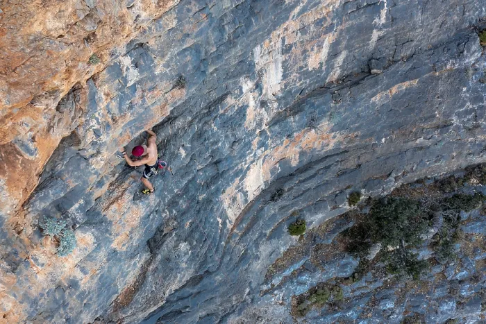 Framed Print : Climber climbing on a rock face
