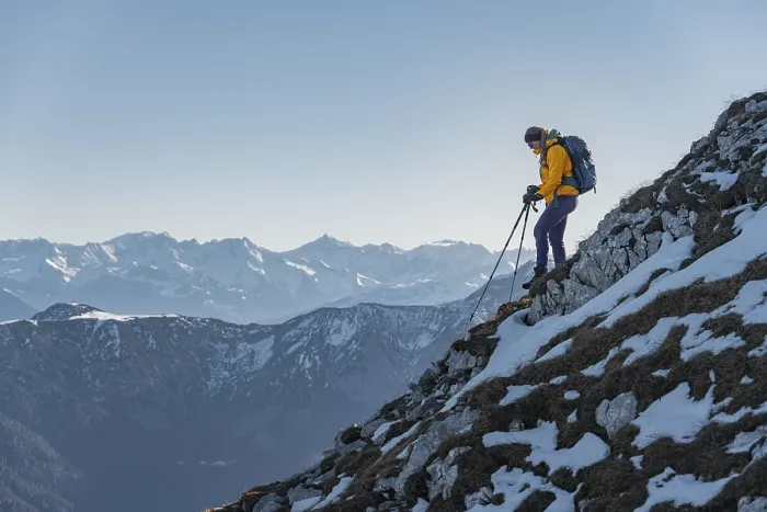 Framed Print : Climber on a ledge, snow-covered mountains Framed Print : Climber on a ledge, snow-covered mountains