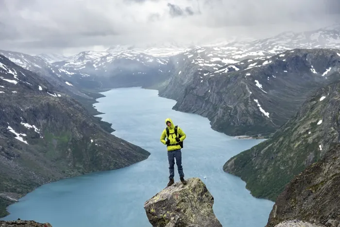 Framed Print : Climber standing on rocks, Besseggen hike