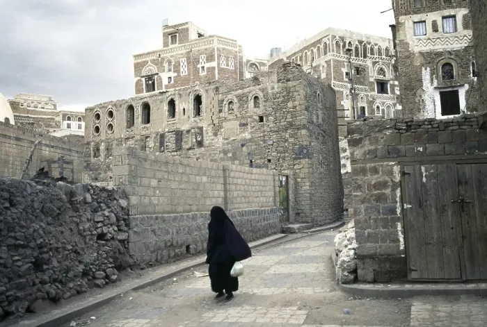 Framed Print : Cloaked woman, historic town centre