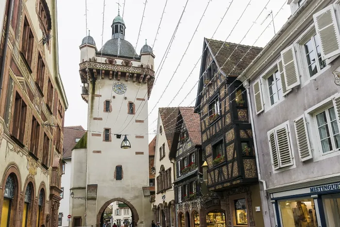 Framed Print : Clock tower and artfully painted half-timbered houses