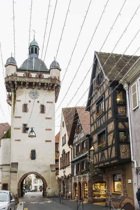 Framed Print : Clock tower and artfully painted half-timbered houses