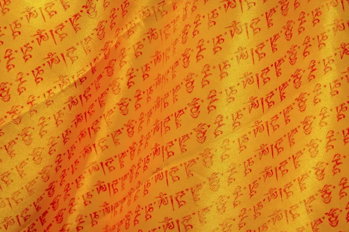 Framed Print : Close up of buddhist prayers on the yellow orange praying flag