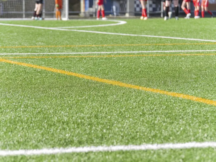 Framed Print : Close up of a green artificial texture soccer field with bright white and yellow lines Framed Print : Close up of a green artificial texture soccer field with bright white and yellow lines
