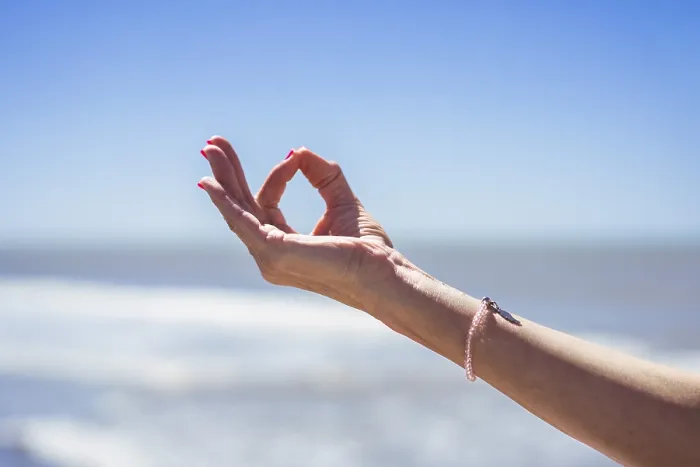 Framed Print : Close up of a mid-adult woman hand performing the Gyan Mudra at the beach Framed Print : Close up of a mid-adult woman hand performing the Gyan Mudra at the beach