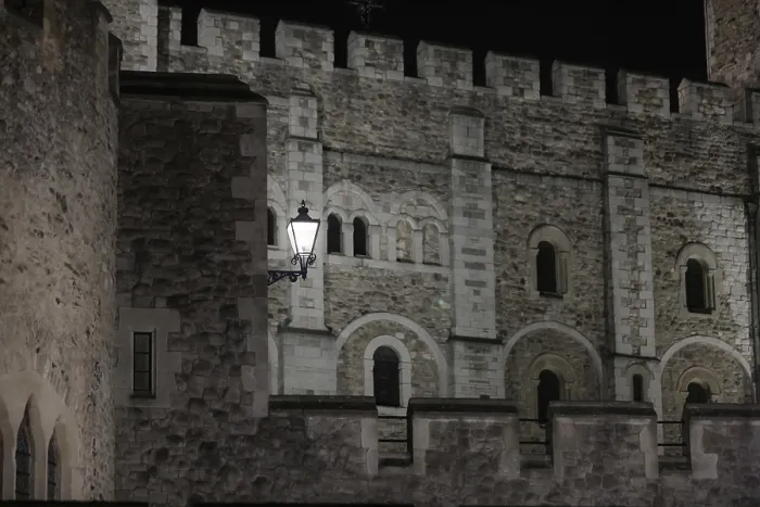 Framed Print : Close-up of a castle's stone wall with intricate architectural details at night at The Tower of London