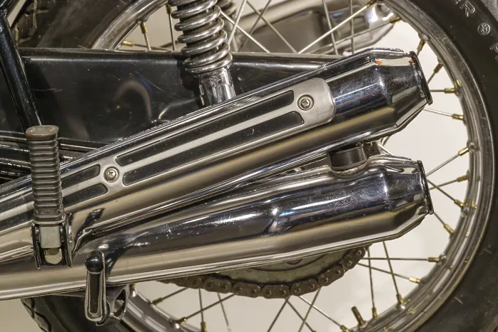 Framed Print : Close-up of a chrome-plated motorbike exhaust and tyre Framed Print : Close-up of a chrome-plated motorbike exhaust and tyre