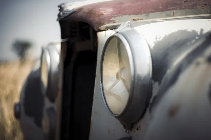 Framed Print : Close-up of a classic Jaguar car's weathered headlights