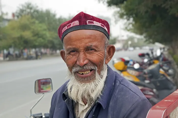 Framed Print : Close-up of an elderly Uighur man with a beard wearing a doppa in Qiemo