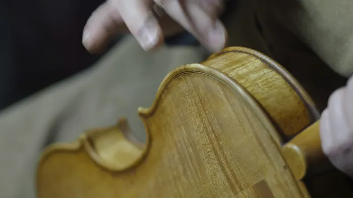 Framed Print : Close-up of hands crafting a violin