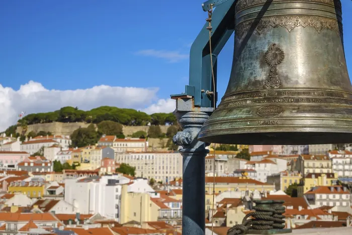 Framed Print : Close-up of historic bell in selective focus overlooking Lisbon