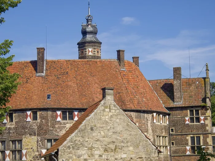 Framed Print : Close-up of a historic building with red tile roof and timbering under a clear sky