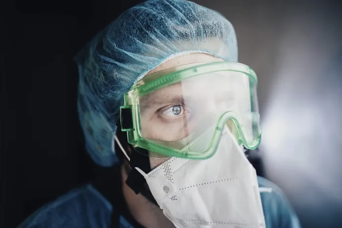 Framed Print : Close-up of a medical professional wearing green goggles and a mask