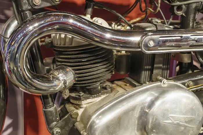 Framed Print : Close-up of a motorbike engine with chrome-plated exhaust pipe