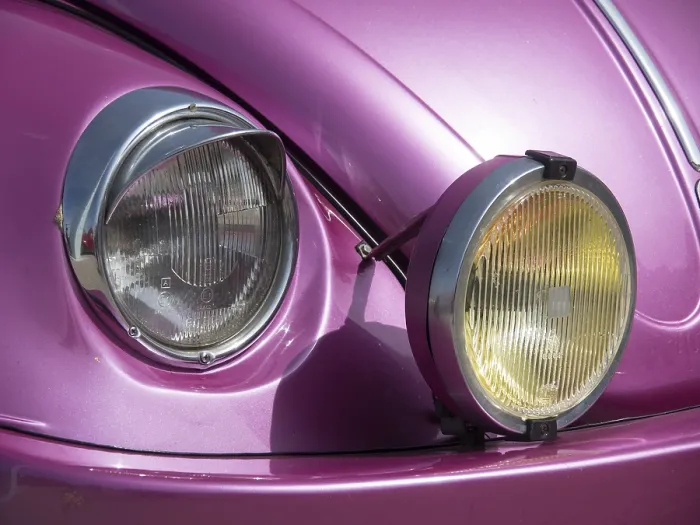 Framed Print : Close-up of the front of a pink classic car with characteristic twin headlights Framed Print : Close-up of the front of a pink classic car with characteristic twin headlights