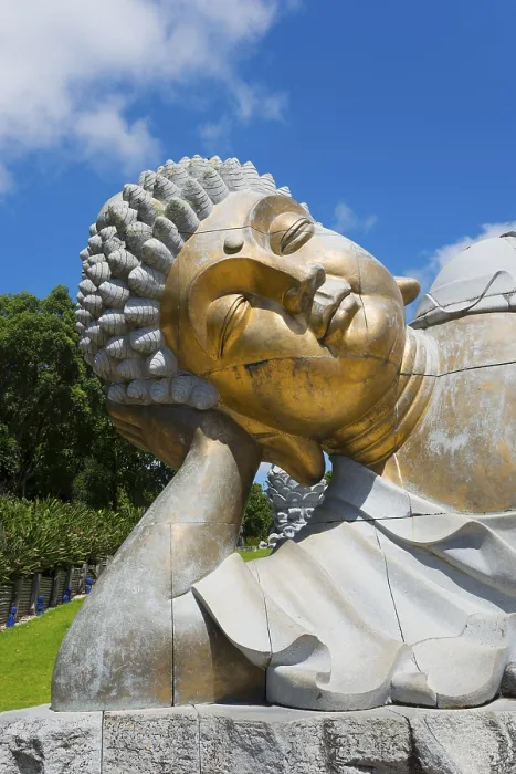 Framed Print : Close-up of a reclining Buddha statue radiating meditative calm against a clear blue sky