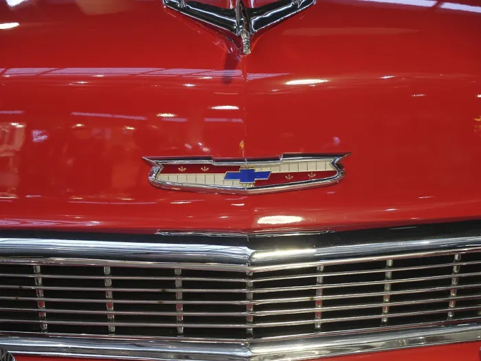 Framed Print : Close-up of a red classic car with distinctive emblem and radiator grille