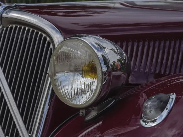 Framed Print : Close-up of a red vintage car with round chrome headlights