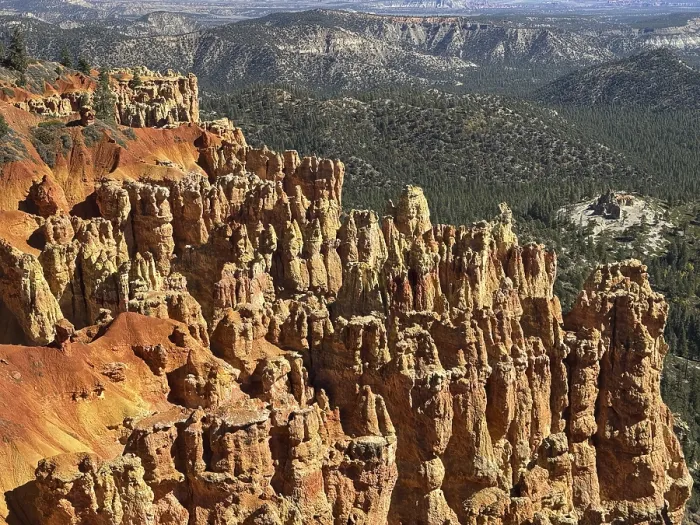 Framed Print : Close-up of textured red rock walls and sweeping views across green valleys Framed Print : Close-up of textured red rock walls and sweeping views across green valleys