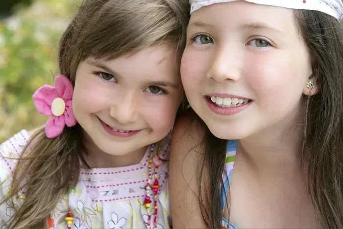 Framed Print : Closeup portrait of two little happy beautiful girl sisters Framed Print : Closeup portrait of two little happy beautiful girl sisters