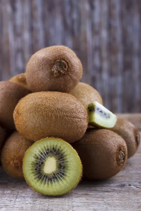 Framed Print : Closeup of ripe kiwi on old rustic wooden table