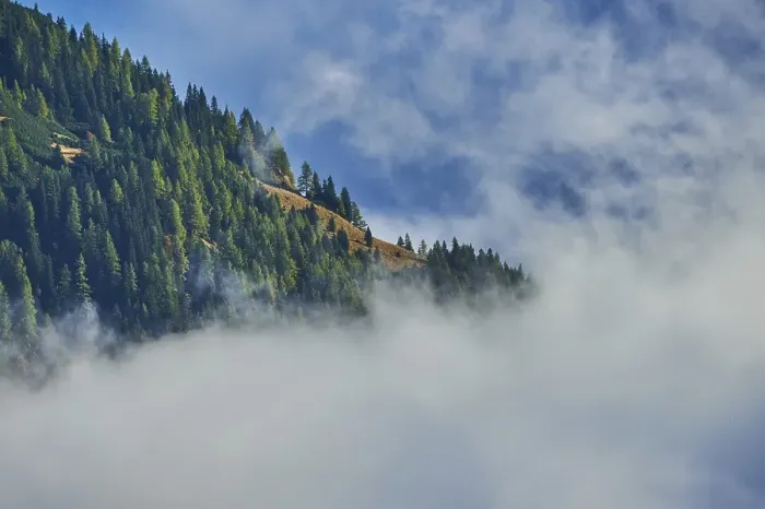 Framed Print : Clouds lying in the valley between Mountains at Hochalpenstrasse