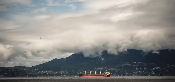 Framed Print : Cloudy sky over mountains with cargo ships on the ocean Framed Print : Cloudy sky over mountains with cargo ships on the ocean