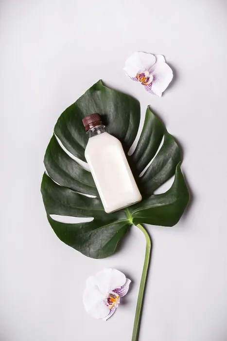 Framed Print : Coconut oil and tropical leaves and flowers