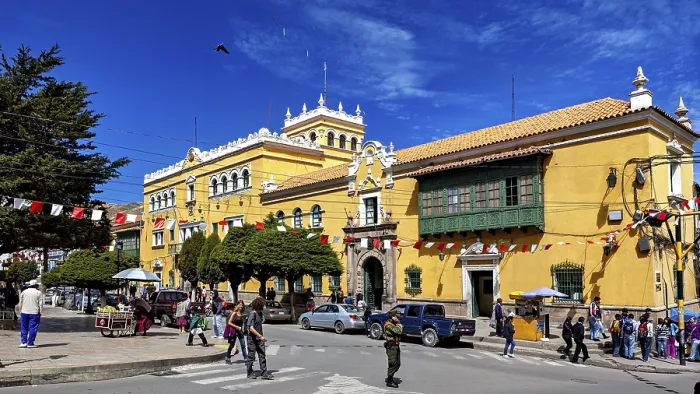 Framed Print : Colonial-style building with market scene and decorative flags Framed Print : Colonial-style building with market scene and decorative flags