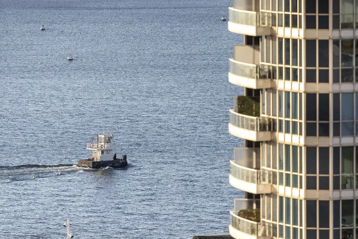 Framed Print : A color image of a boat on the water beside a modern apartment building in Toronto