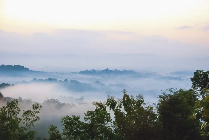 Framed Print : Colorful sunrise over jungle with Merapi volcano behind and Borobudur temple Framed Print : Colorful sunrise over jungle with Merapi volcano behind and Borobudur temple