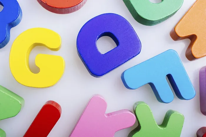 Framed Print : Colorful wooden letters scattered on a white background Framed Print : Colorful wooden letters scattered on a white background