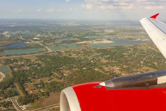 Framed Print : A colour landscape image looking out through airplane window showing land