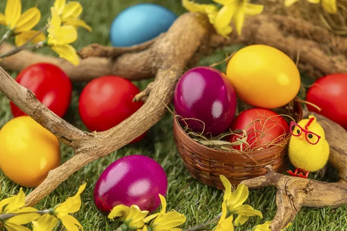 Framed Print : Colourful Easter eggs in and around a small basket Framed Print : Colourful Easter eggs in and around a small basket