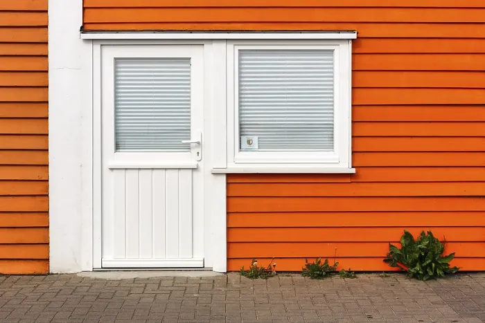 Framed Print : Colourful lobster shack, orange wooden facade with door and window
