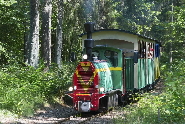 Framed Print : A colourful train runs through a sunny
