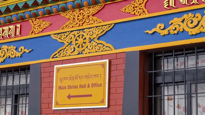 Framed Print : Colourfully decorated facade with a sign in two languages referring to a main sanctuary and office Framed Print : Colourfully decorated facade with a sign in two languages referring to a main sanctuary and office