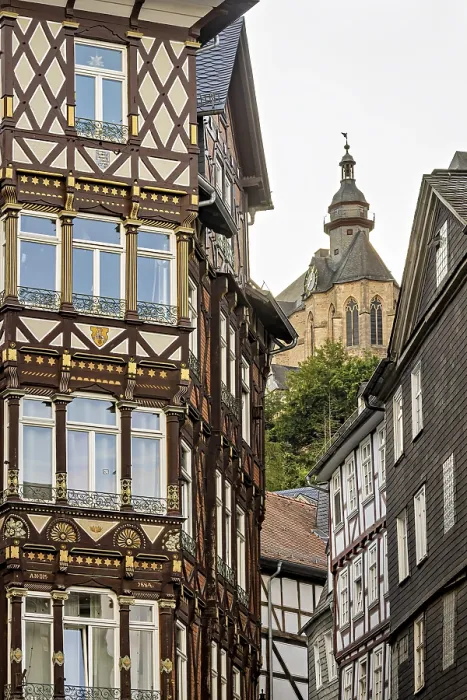 Framed Print : Combination of elaborate half-timbered details and Gothic church tower in the cityscape Framed Print : Combination of elaborate half-timbered details and Gothic church tower in the cityscape