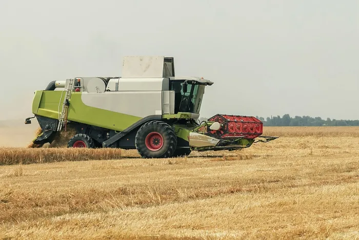 Framed Print : Combine harvester working on a wheat field