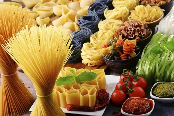 Framed Print : Composition with different sorts of pasta on kitchen table