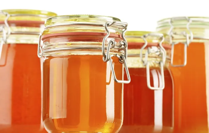 Framed Print : Composition with jars of honey isolated on white background Framed Print : Composition with jars of honey isolated on white background