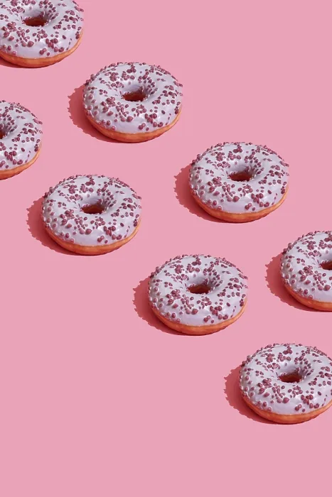 Framed Print : Concept food design with tasty pink glazed donut with red flakes on coral pink pastel background top view pattern
