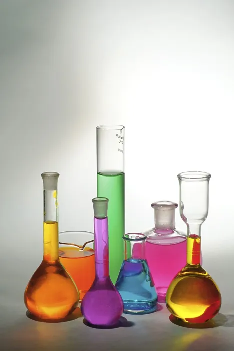 Framed Print : Concept, various colourful chemicals in beakers on white background