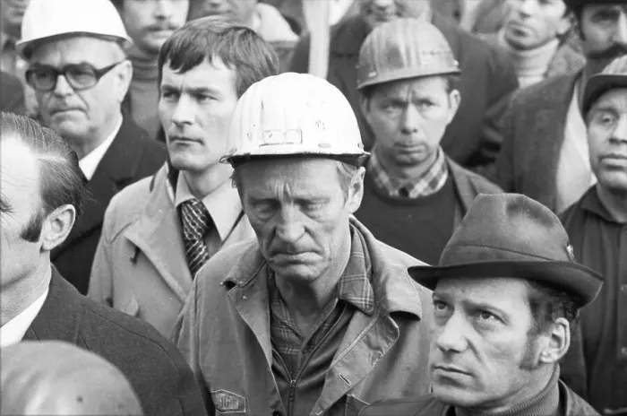 Framed Print : The concern for their jobs is written all over the faces of the workers Framed Print : The concern for their jobs is written all over the faces of the workers