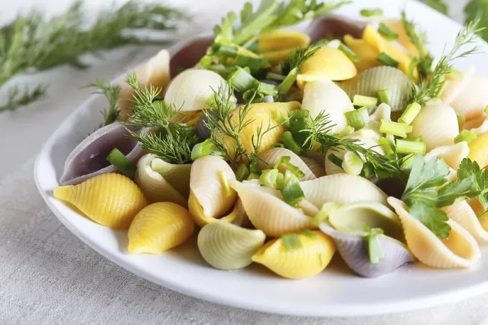 Framed Print : Conchiglie colored pasta with fresh greengrocery on a linen tablecloth on white wooden background