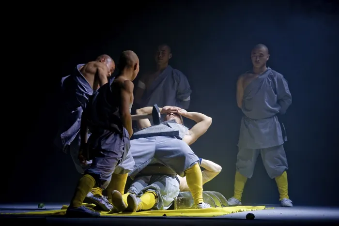 Framed Print : A concrete slab is being smashed on a monk while he is lying on a bed of nails