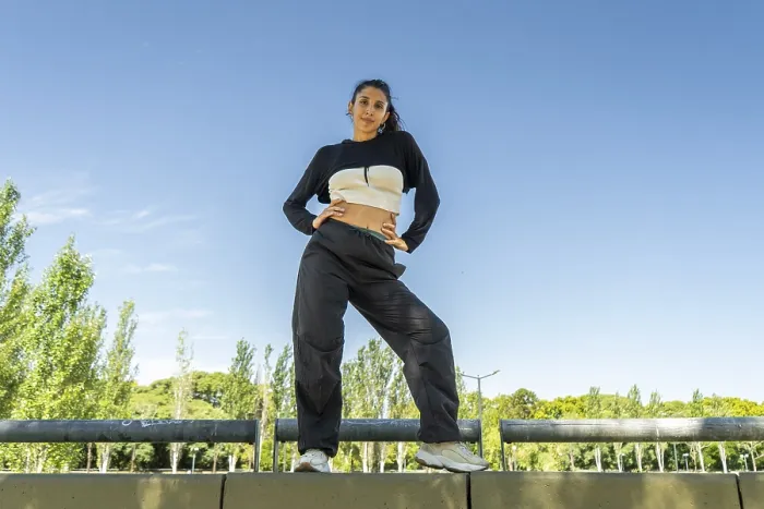 Framed Print : Confident urban dancer striking a pose in a sunny park Framed Print : Confident urban dancer striking a pose in a sunny park