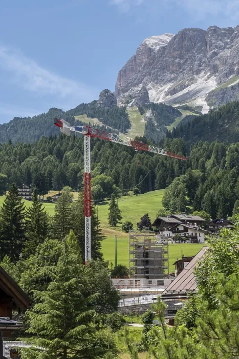 Framed Print : Construction crane in front of a mountain backdrop in Cortina