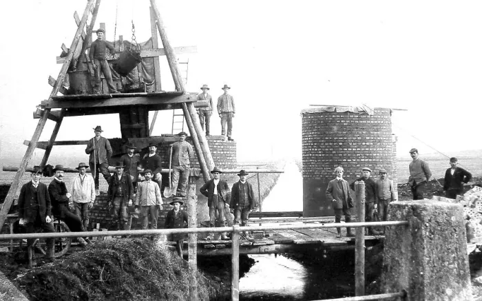 Framed Print : Construction site, masons building a factory