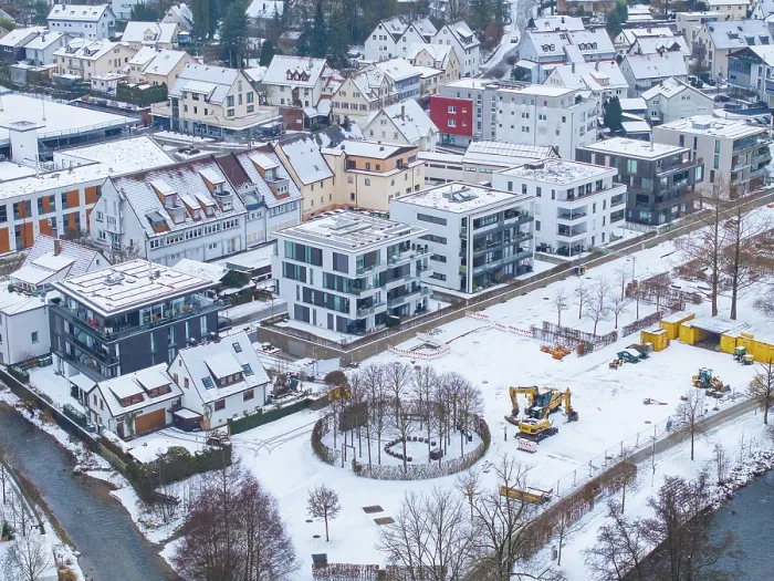 Framed Print : Construction site next to modern residential buildings in a snowy cityscape